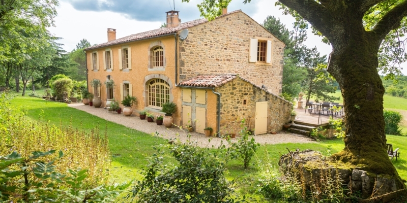 Estate Garden Featuring Arched Ground Floor Windows & Ochre Facade