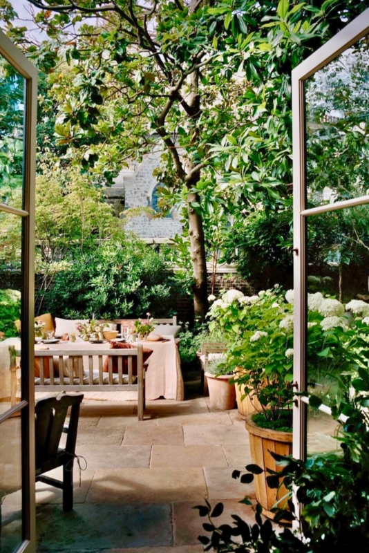 European Flagstone Patio Garden with Lush White Hydrangeas