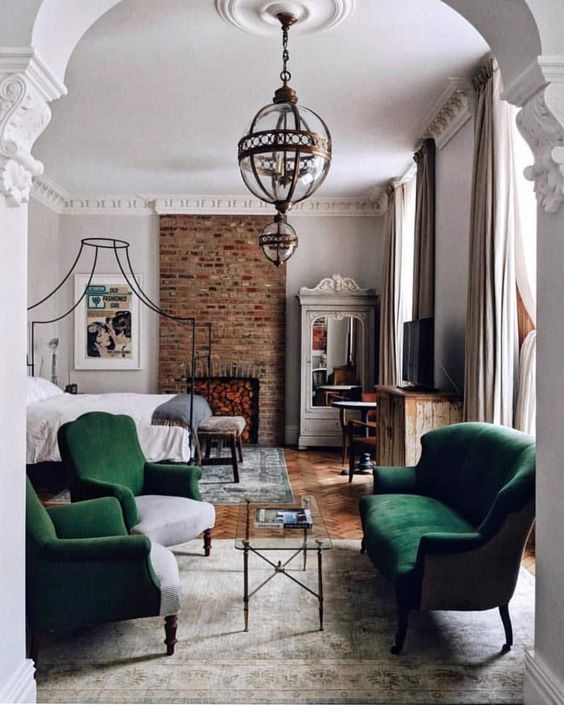 European Villa Bedroom: Emerald Velvet Seating & Brick Fireplace