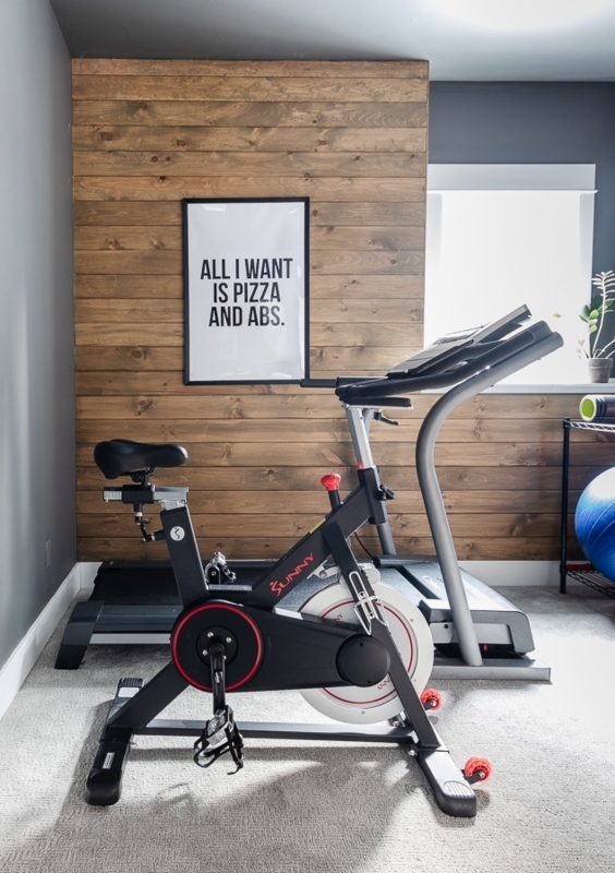 Exercise Bike In Compact Workout Room With Wood Plank Accent Wall
