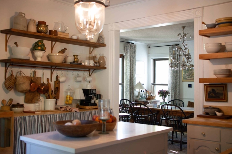 Farmhouse Copper Pot Storage with Layered Shelving and Archway View