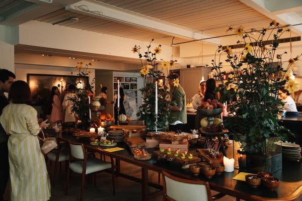 Festive Dinner Party Table Setting: Towering Yellow Floral Centerpieces