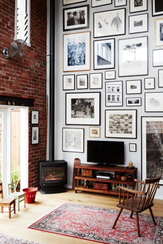 Floor to Ceiling Gallery Wall with Exposed Brick Accent