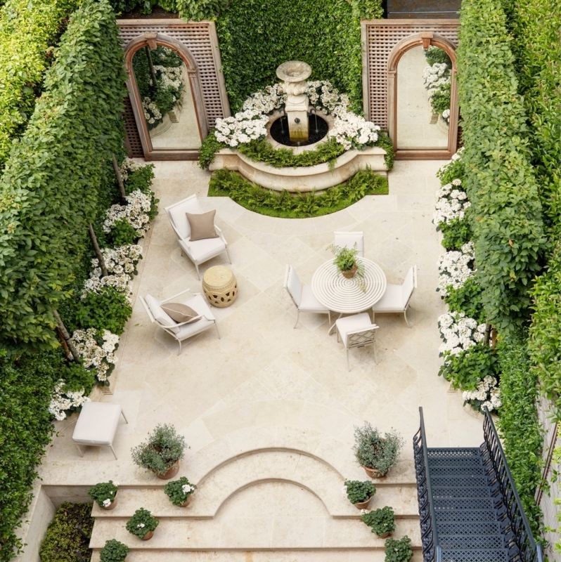 Formal French Country Courtyard with Arched Garden Mirrors on Hedges
