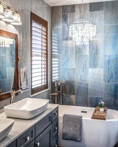 Freestanding Bathtub with Stone Tiles, Crystal Chandelier and Shutters