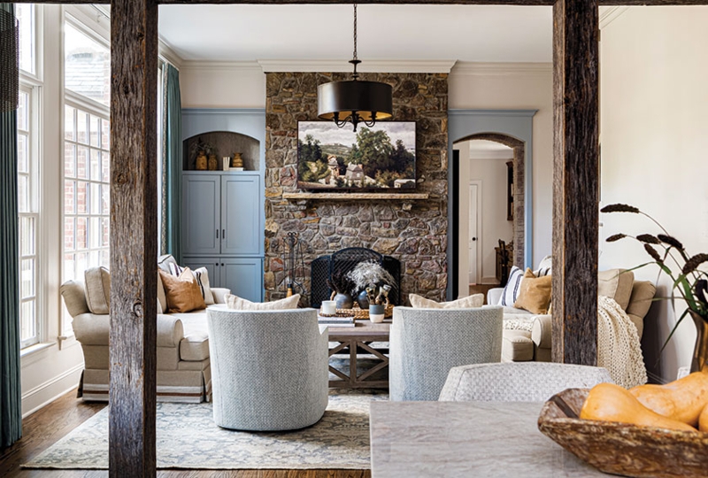 French Country Living Room Layout with Blue Built-Ins & Exposed Wood Beams
