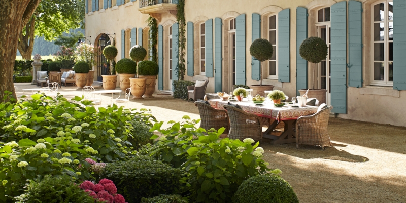 French Country Patio With Blue Shutters & Gravel Terrace Dining