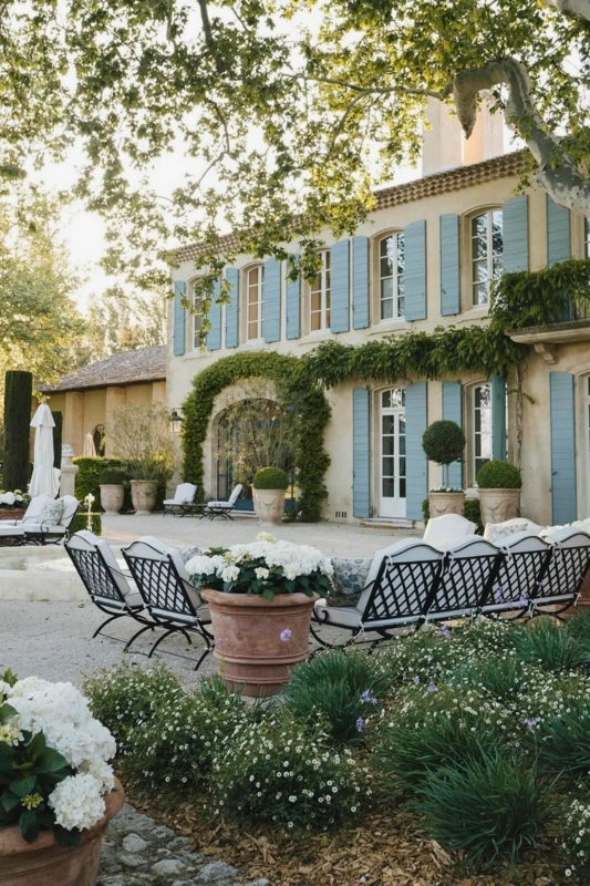 French Provincial Patio with Lattice Back Chairs and Blue Shutters