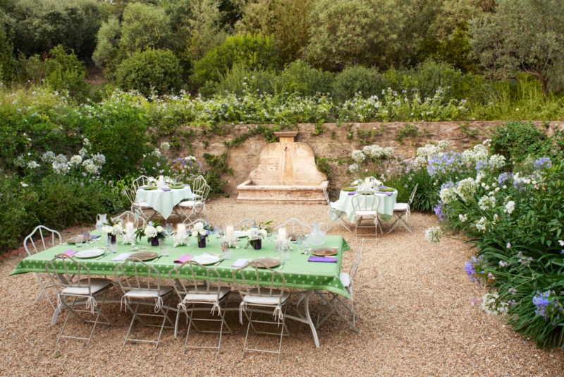 Garden Dining Area With A Wall Fountain & Metal Filigree Chairs