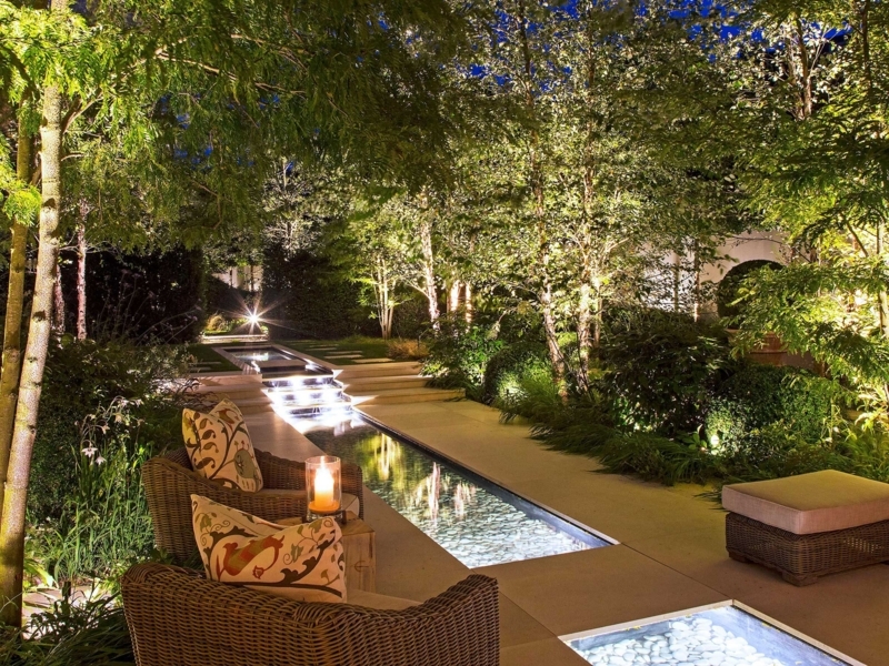 Garden with Linear Water Feature, Tiered Steps, and Woven Outdoor Chairs