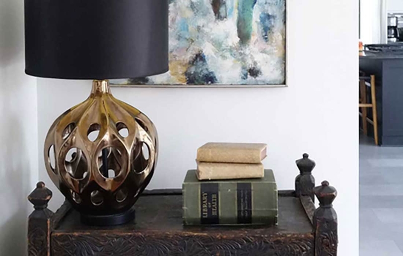 Gold Openwork Table Lamp Styling on Carved Wood Chest