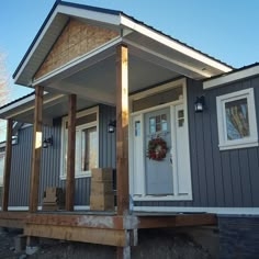 Grey Vertical Siding House Exterior with Unfinished Wood Porch