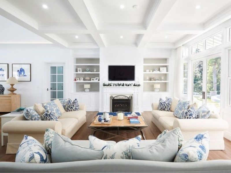 Hamptons Style Rolled Arm Sofas with Coffered Ceiling and Blue Accents