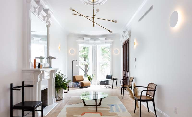 Herringbone Wood Floor Living Space with Ornate White Fireplace Design