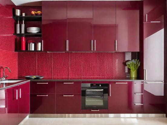 High Gloss Red Kitchen Cabinetry with Ribbed Backsplash and Black Top