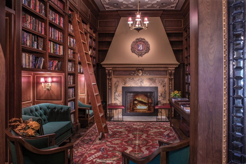 Home Library featuring Grand Fireplace Hood and Rolling Ladder