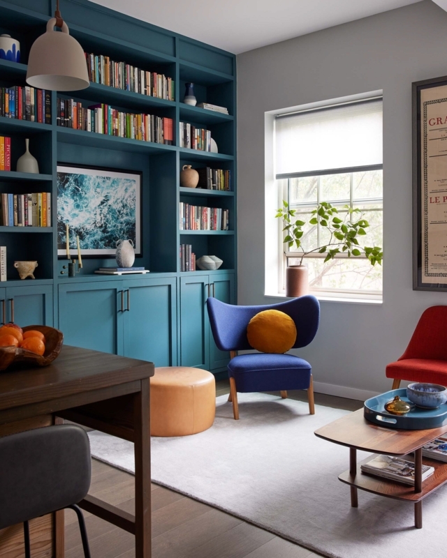 Home Library with Teal Built-In Shelving and Mid-Century Modern Chairs