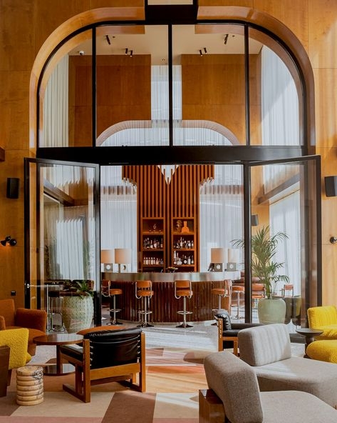 Hotel Bar Area: Tall Arched Frames, Vertical Wood Slats, Honey Paneling