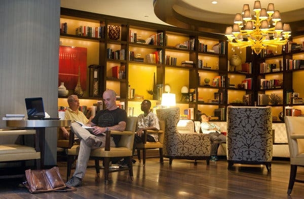 Hotel Lounge with Yellow Tiered Chandelier and Architectural Ceiling