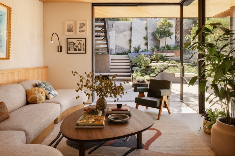 Indoor-Outdoor Living Room Design with Wood Paneled Walls and Garden View
