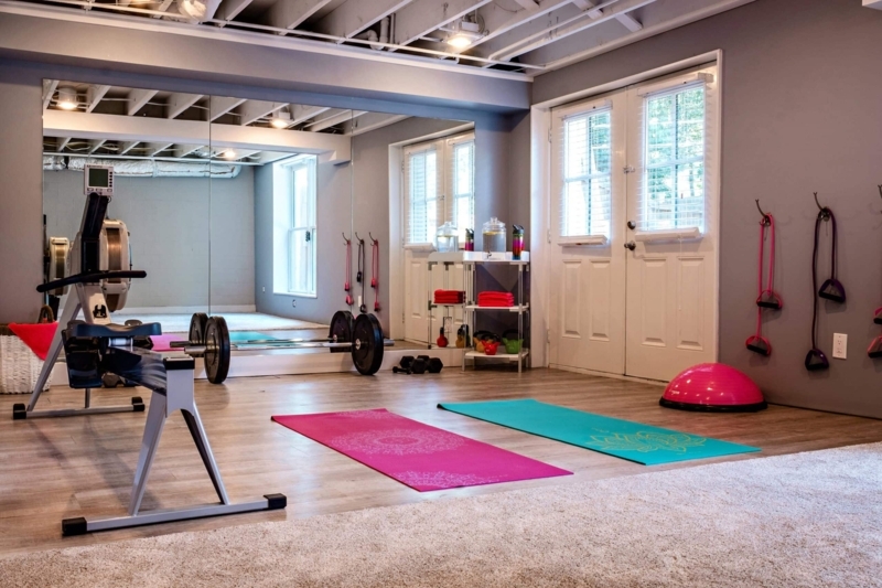 Industrial Basement Gym With Exposed Joists And Mirrored Wall
