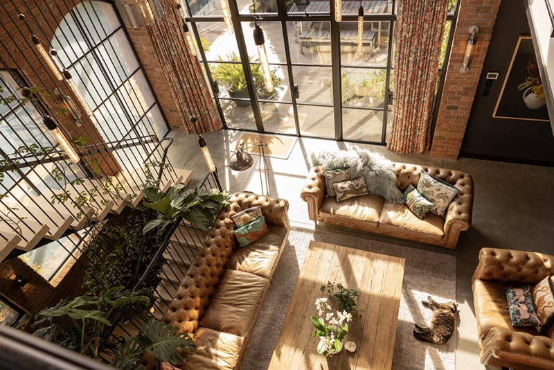 Industrial Loft Living Room: Exposed Brick Walls & Tufted Leather Sofas