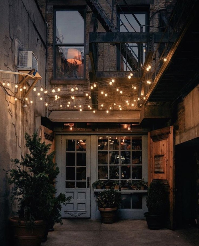 Intimate Urban Courtyard with Warm String Lighting