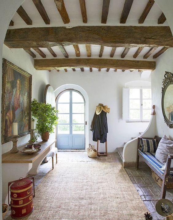 Italian Villa Entryway: Arched Blue Door & Timber Beams