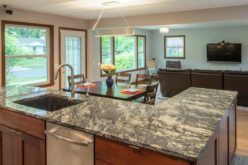 Kitchen Island: Mottled Granite Countertop in Open Concept Great Room