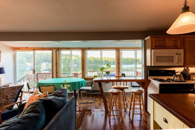 Lakeside Dining Area with Panoramic Windows and Live Edge Bar