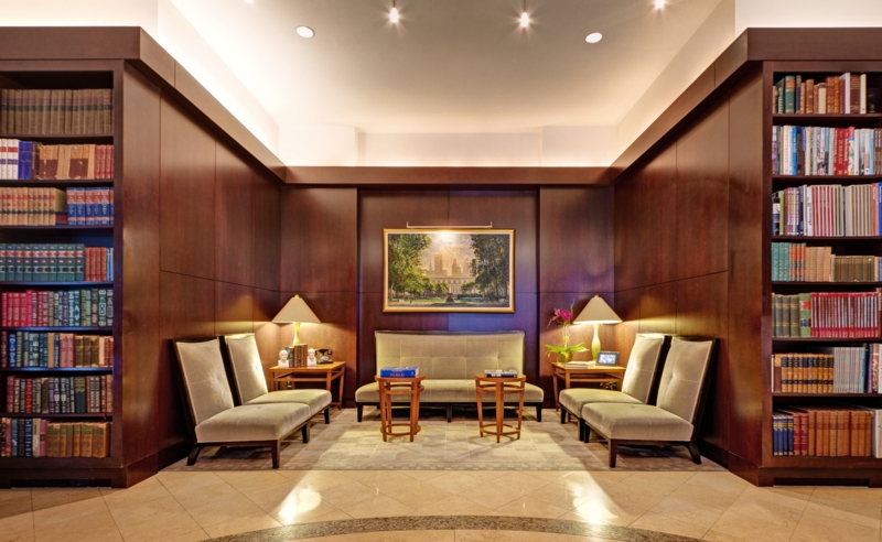 Library Lounge with Dark Wood Paneling and Symmetrical Seating Layout