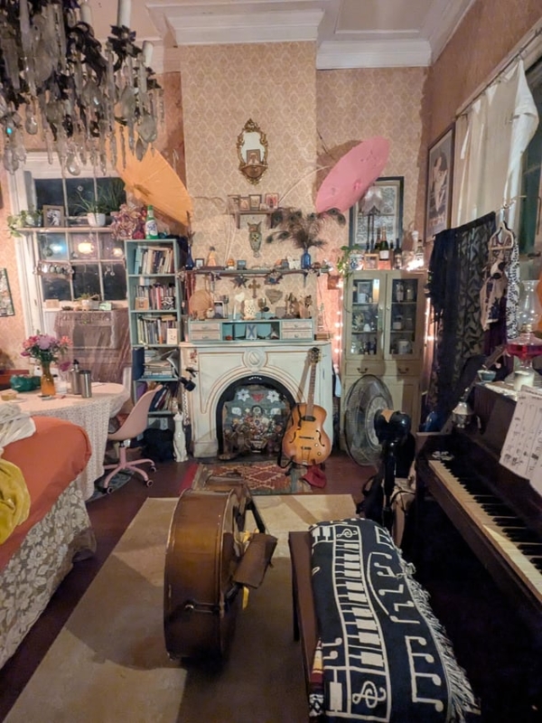 Living Room: Instrument Collection, Ornate Chandelier, Parasol Accents