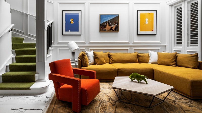Living Room Mustard Sectional and Orange Geometric Chair Decor