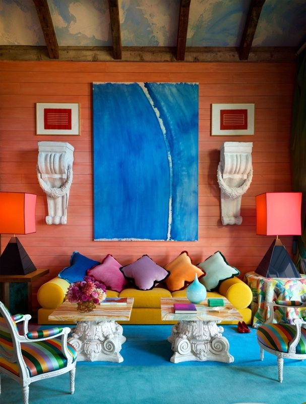 Living Room with Bold Orange Walls and Column Style Coffee Tables