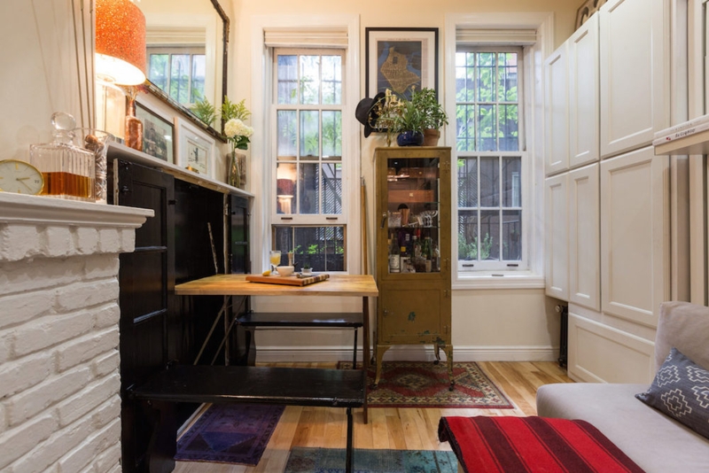 Living Room with Fold Down Table and Painted Brick Fireplace Design