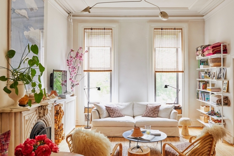 Living Room with Ornate Marble Fireplace, Rattan Chairs and Eclectic Vibe