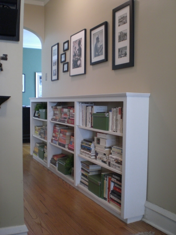 Low Profile White Hallway Bookcase with Gallery Wall Above