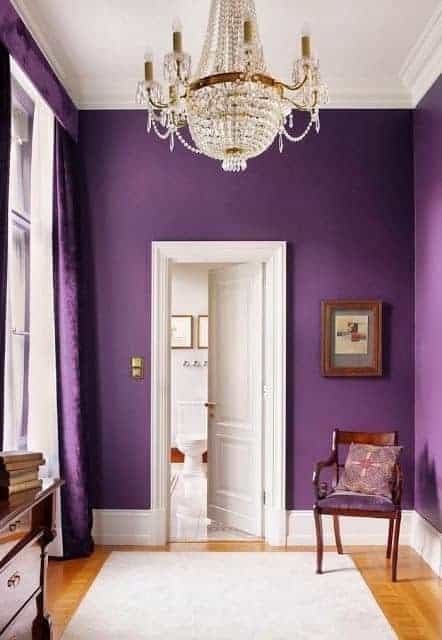 Luxury Hallway with Crystal Chandelier and Dramatic Aubergine Walls