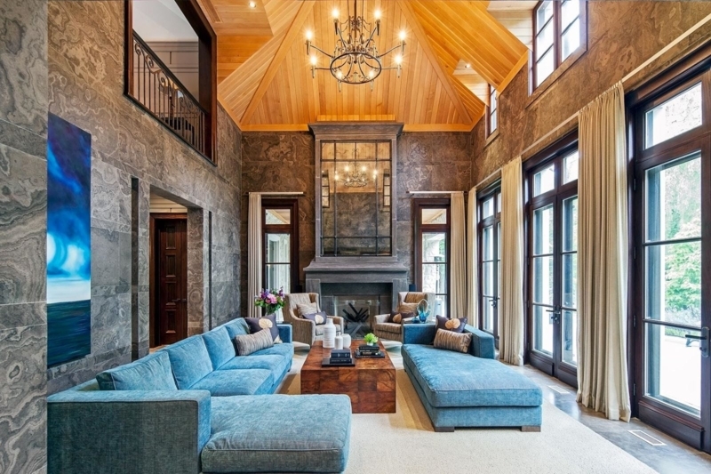 Luxury Living Room with Marbled Stone Walls and Vaulted Wood Ceiling