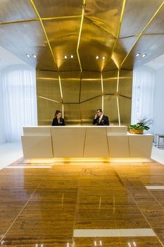 Luxury Reception Area: Faceted Gold Ceiling, Integrated Light Seams