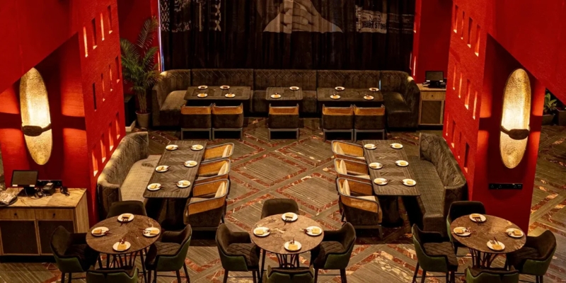 Luxury Restaurant Interior: Red Textured Walls & Large Sconces