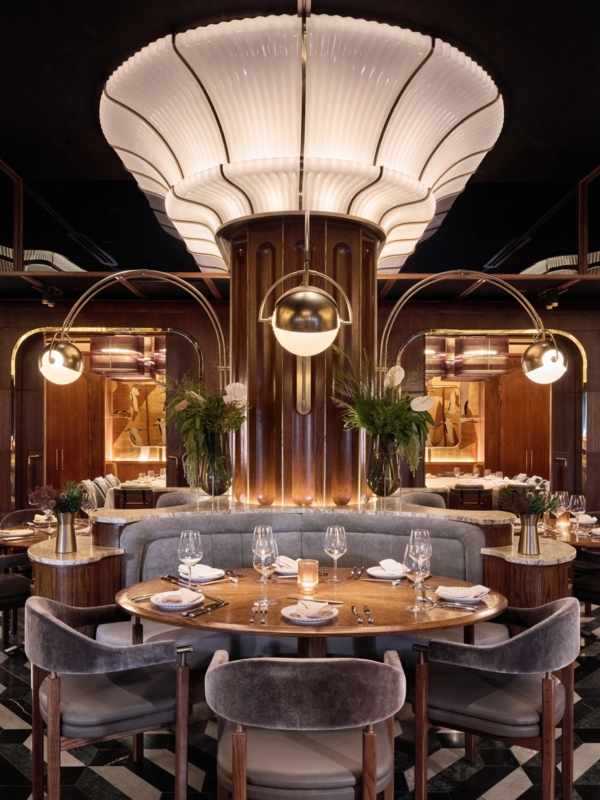 Luxury Steakhouse Interior: Central Fluted Light & Curved Banquettes