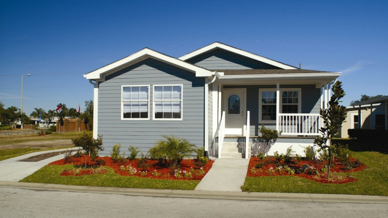 Manufactured Home Curb Appeal Ideas with Blue Gray Siding and Red Mulch