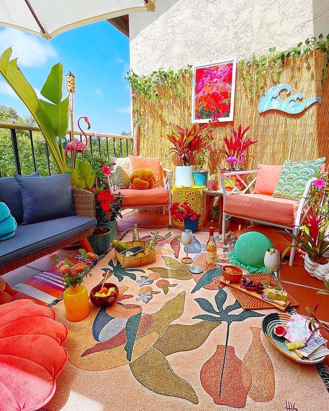 Maximalist Balcony: Bamboo Privacy Screen and Vibrant Botanical Rug