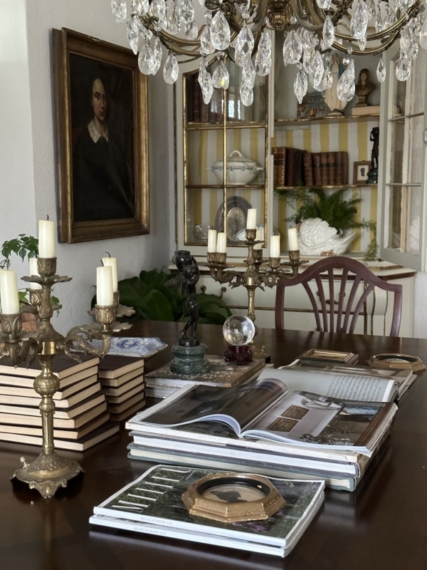 Maximalist Dining Room Scene with Brass Candelabras and Striped Cabinet
