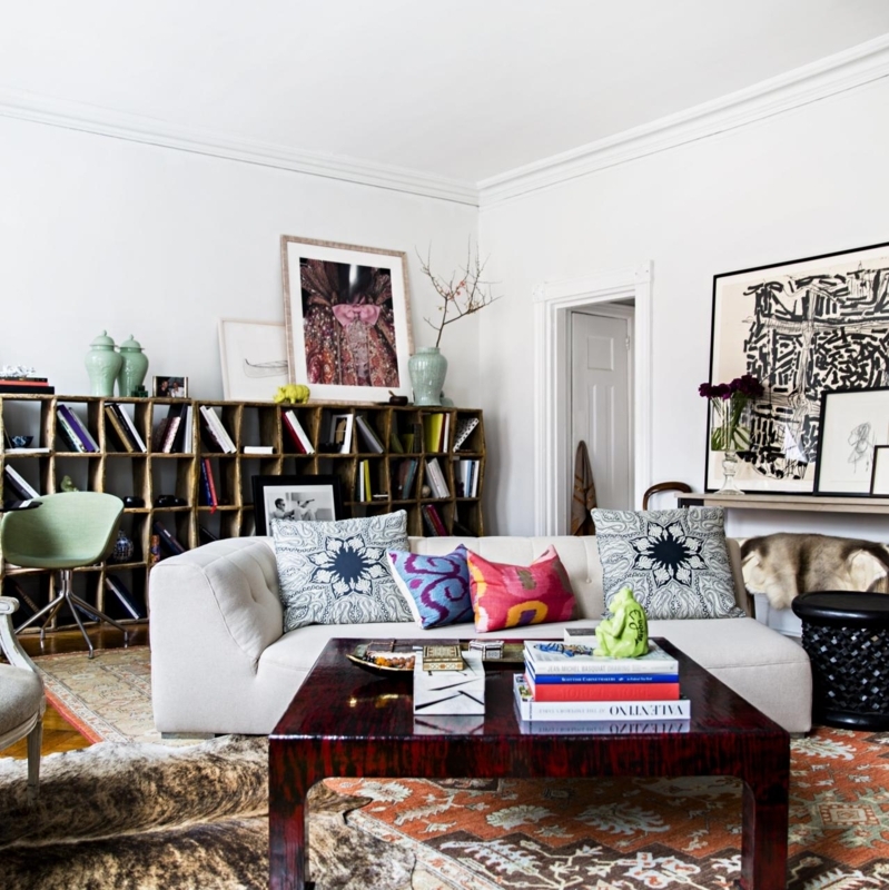 Maximalist Living Room with Grid Bookshelf and Layered Rugs