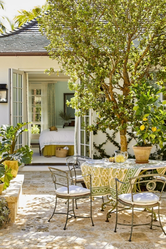 Mediterranean Stone Patio with Dappled Shade and Potted Lemon Tree