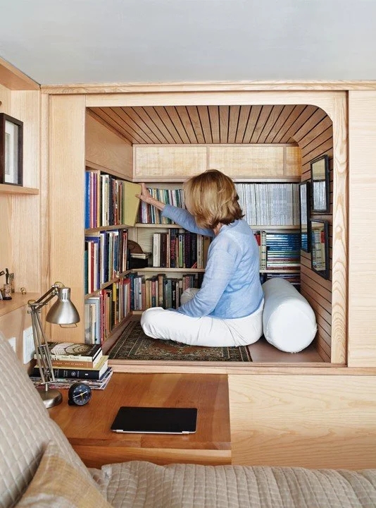 Minimalist Built-In Nook with recessed alcove and light wood shelving.