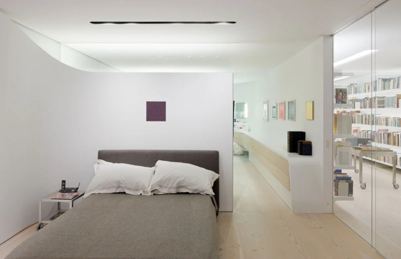 Minimalist Loft Bedroom Layout: Glass Partition & Curved White Walls