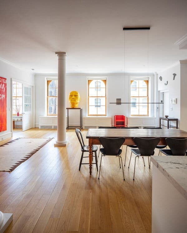 Minimalist Loft Dining Room: Arched Windows & Sculptural Art Accents